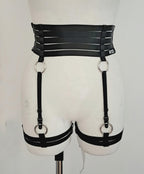 Black satin shine strappy garter belt on a mannequin against a white background