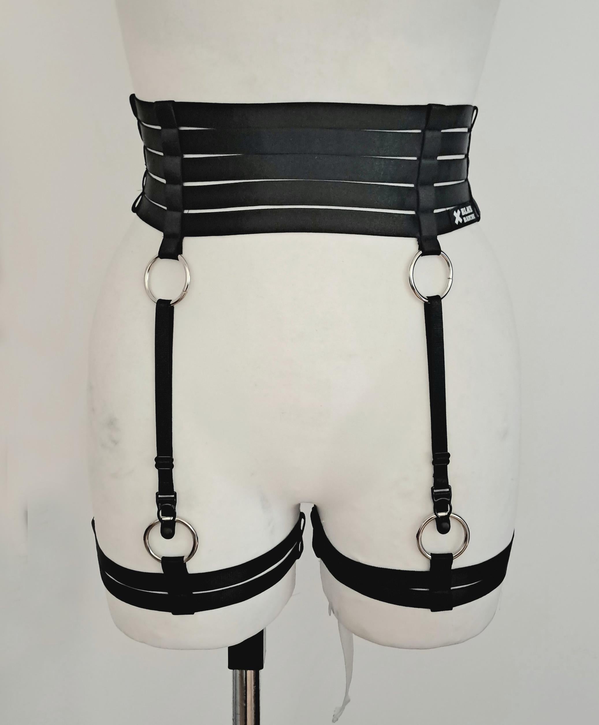Black satin shine strappy garter belt on a mannequin against a white background