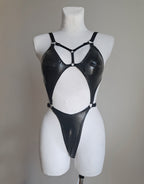Black bodysuit on a mannequin against a plain background