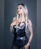 Person wearing a silver bodysuit  with a gray background