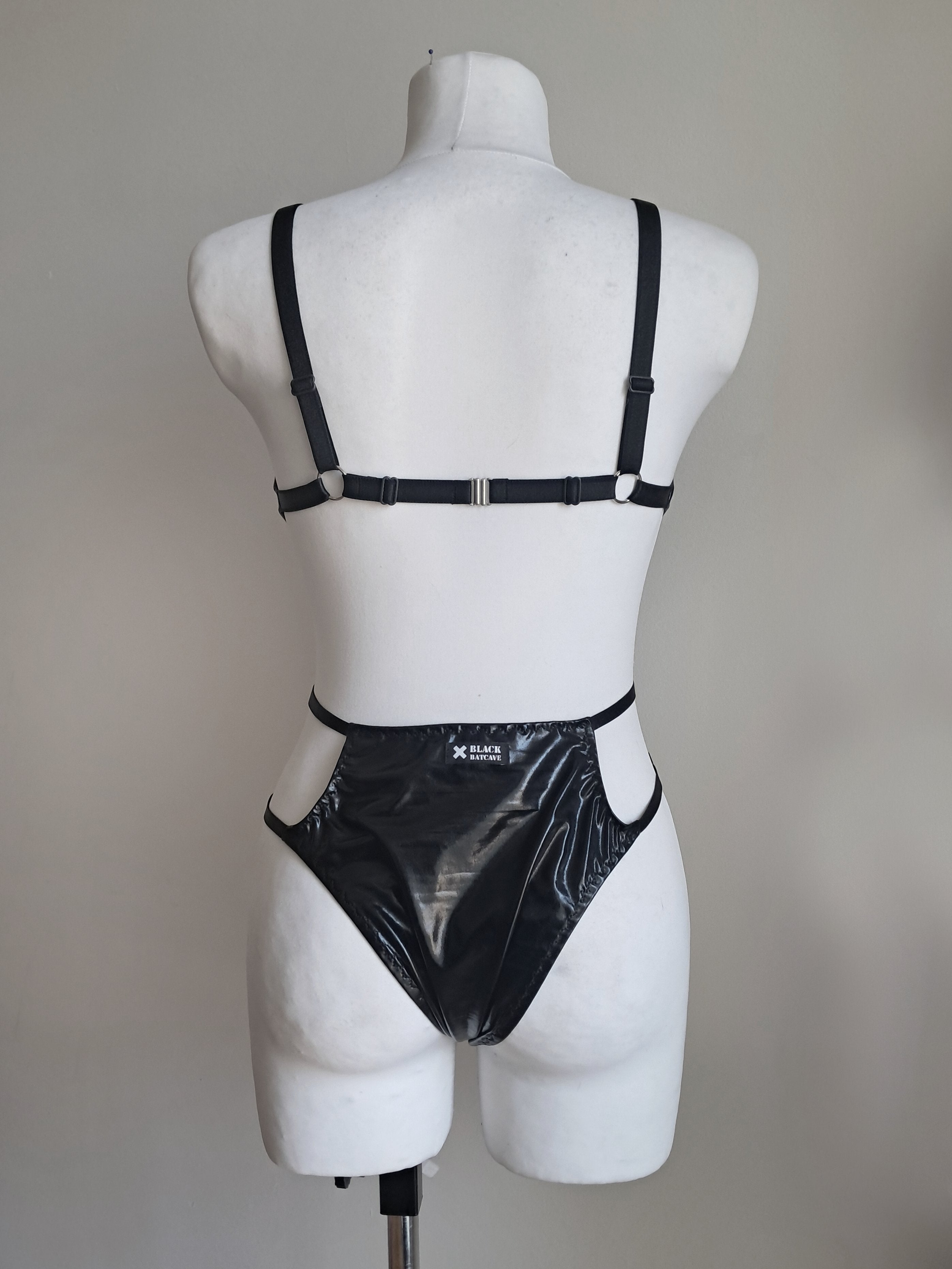 Black bodysuit  on a mannequin against a plain background