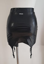 Blackwet look mini skirt with suspenders on a mannequin against a plain background
