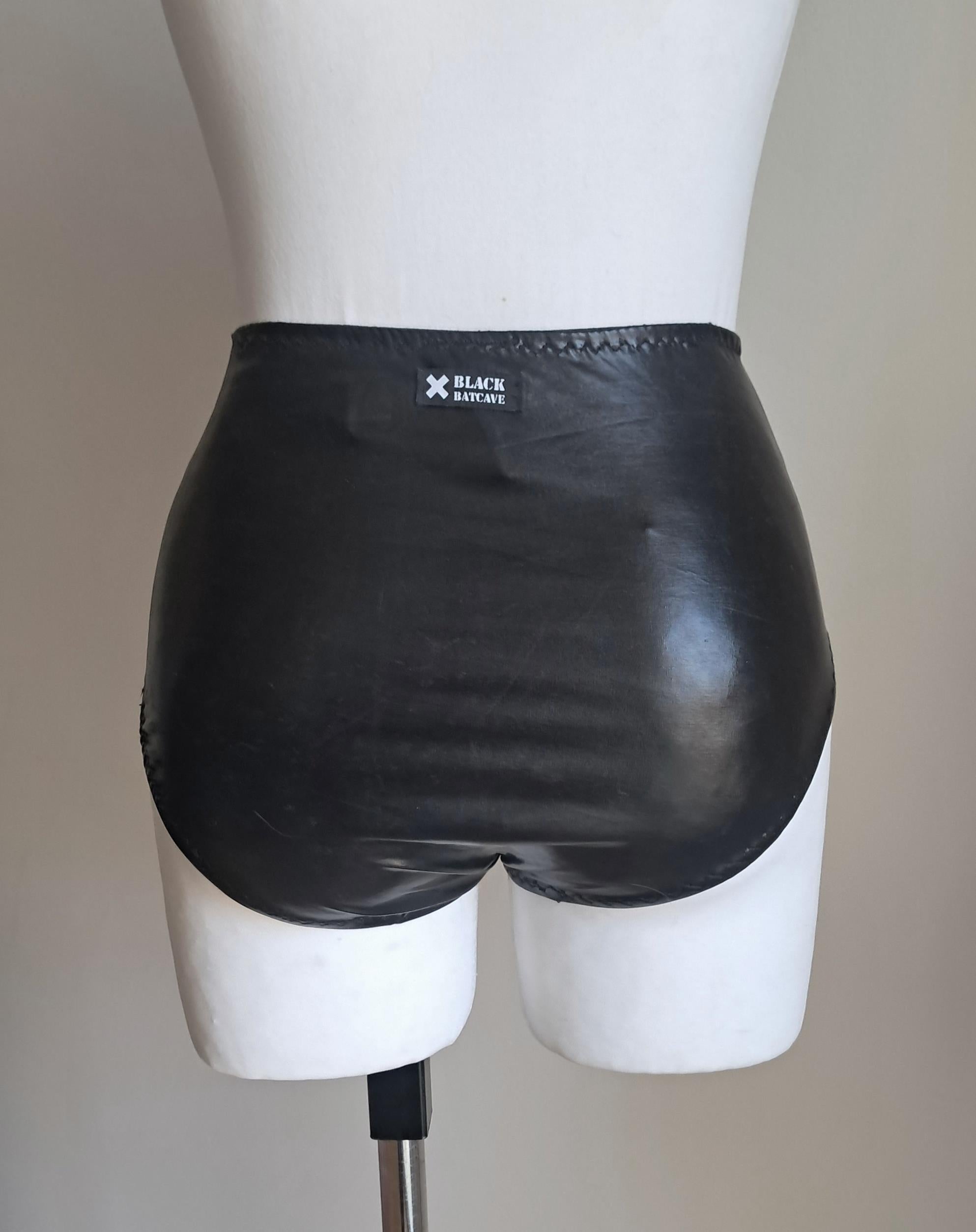 Black wet-look high waist panties on a mannequin against a plain background