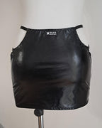 Blackwet-look cut-out mini skirt on a mannequin against a plain background