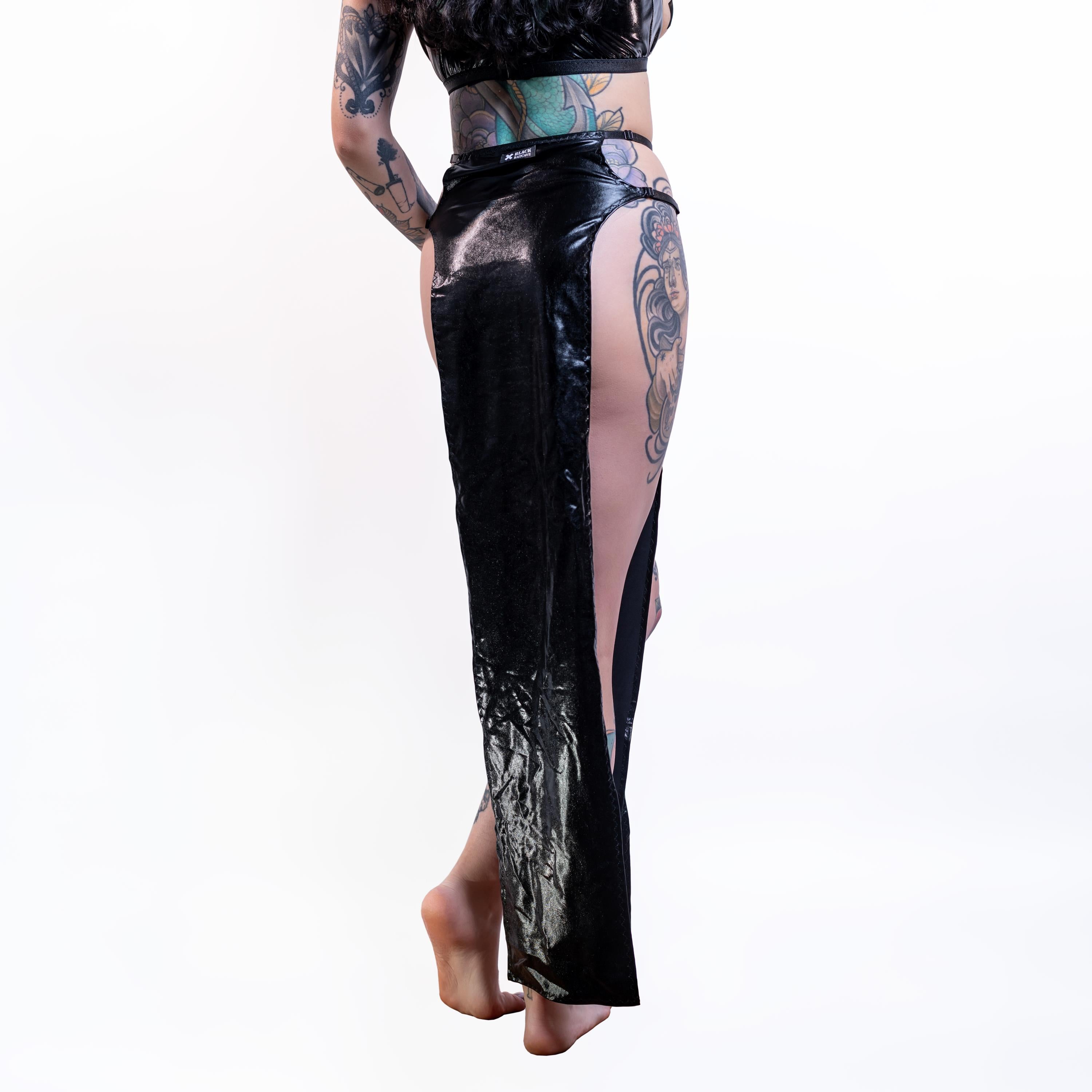 Black wet-look cut-out maxi skirt with sheer panels worn by a person on a white background