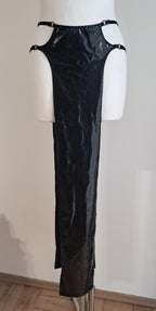 Black wet-look cut-out maxi skirt on a mannequin against a plain background
