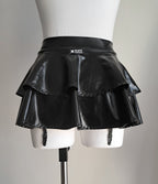 Black wet-look mini skirt with suspenders on a mannequin against a plain background