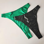 Green and black wet look high waist thongs on a light gray background
