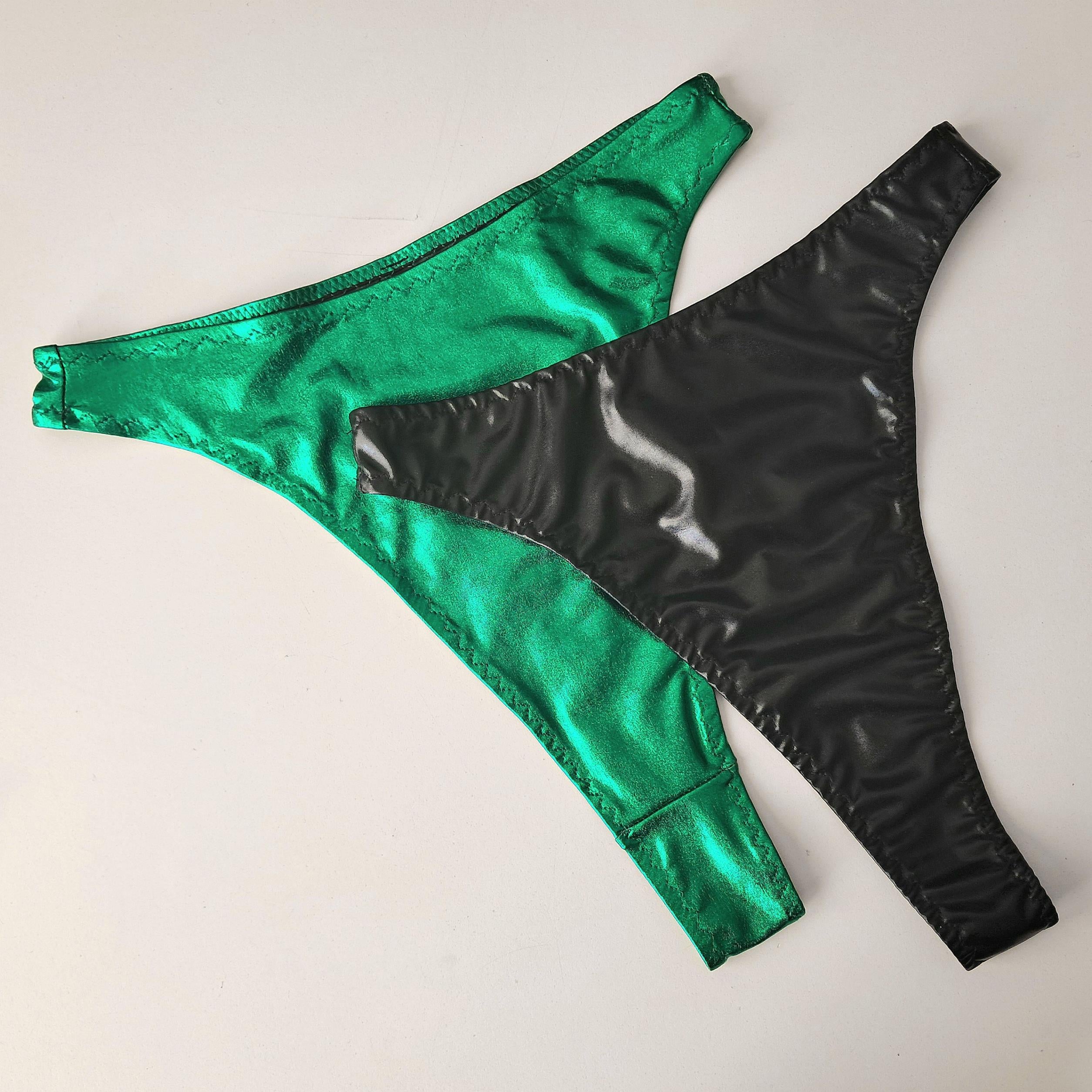 Green and black wet look high waist thongs on a light gray background