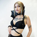 Woman wearing a black vampire collar harness on a white background