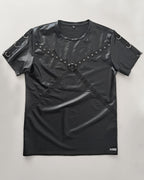 Black leather-like top with shoulder straps and studs on a light gray background