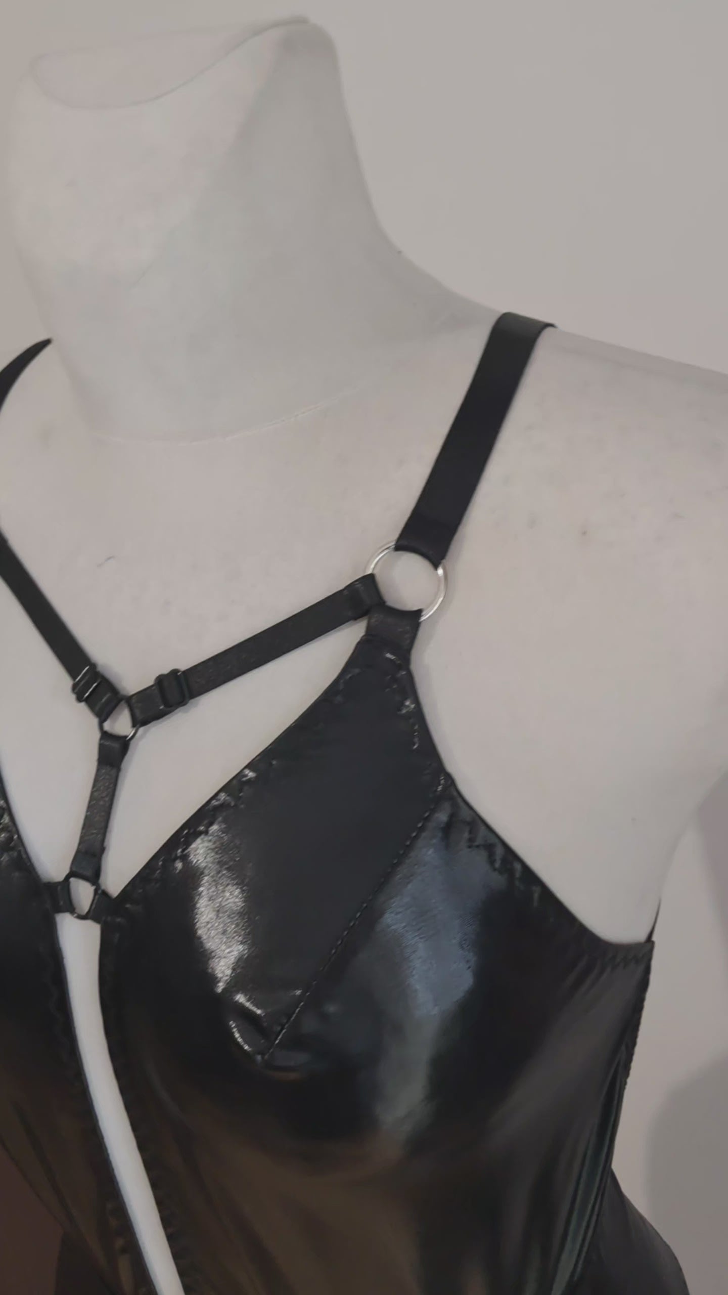 black wet look bodysuit presented on mannequin