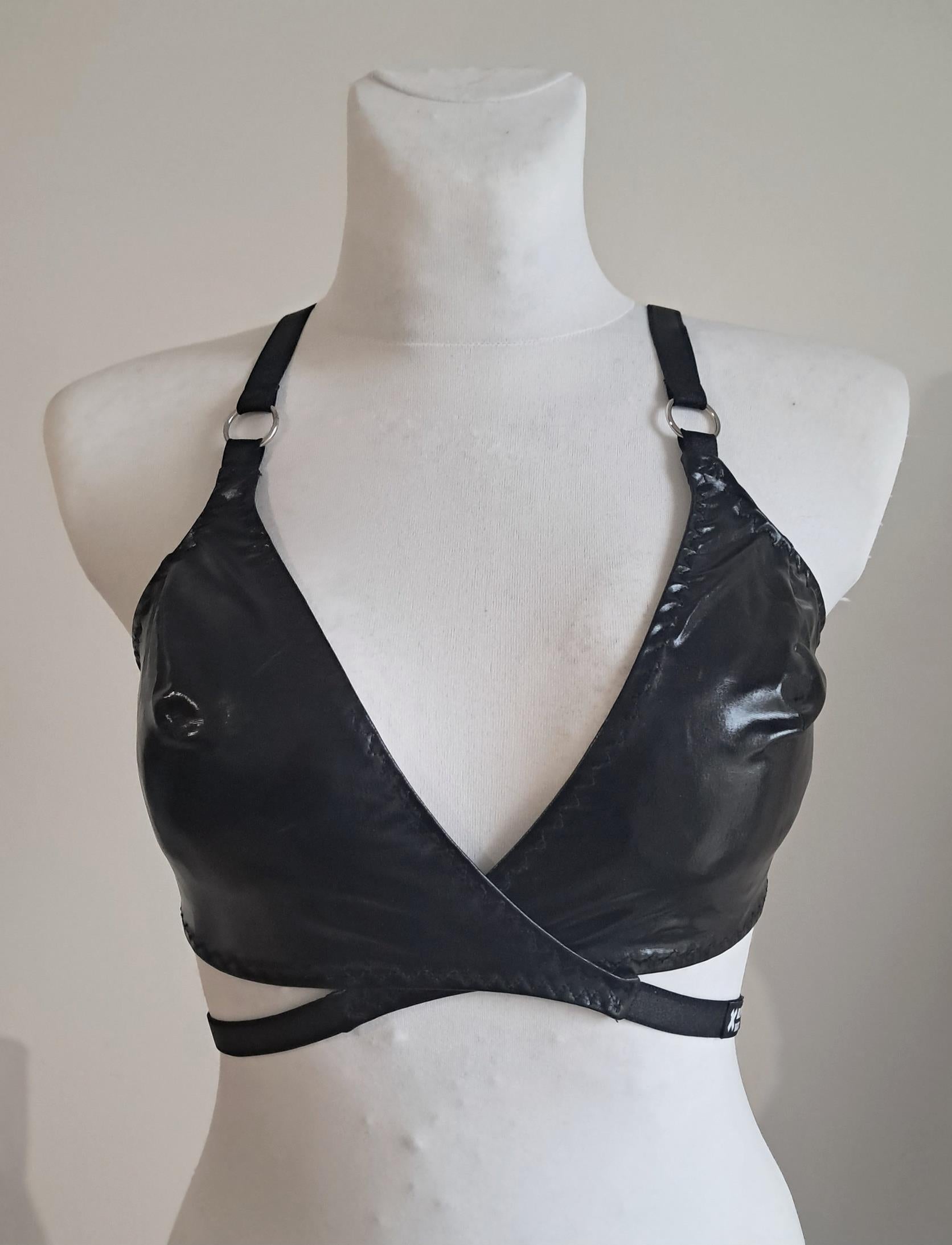 Black wet look wrap bra on a mannequin against a plain background