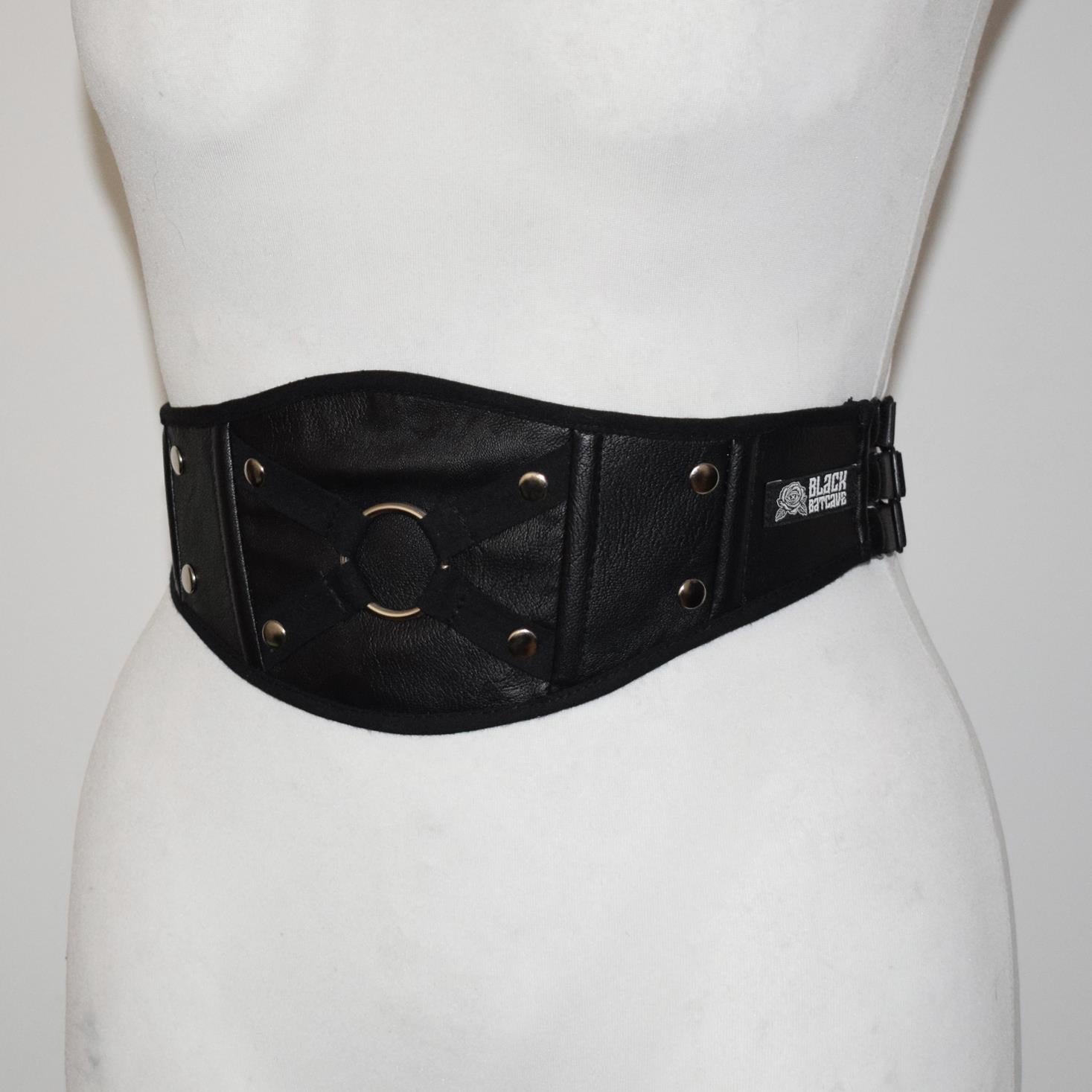 Black leather belt with gold accents on a mannequin against a white background