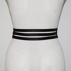 Black belt with three straps on a mannequin against a white background