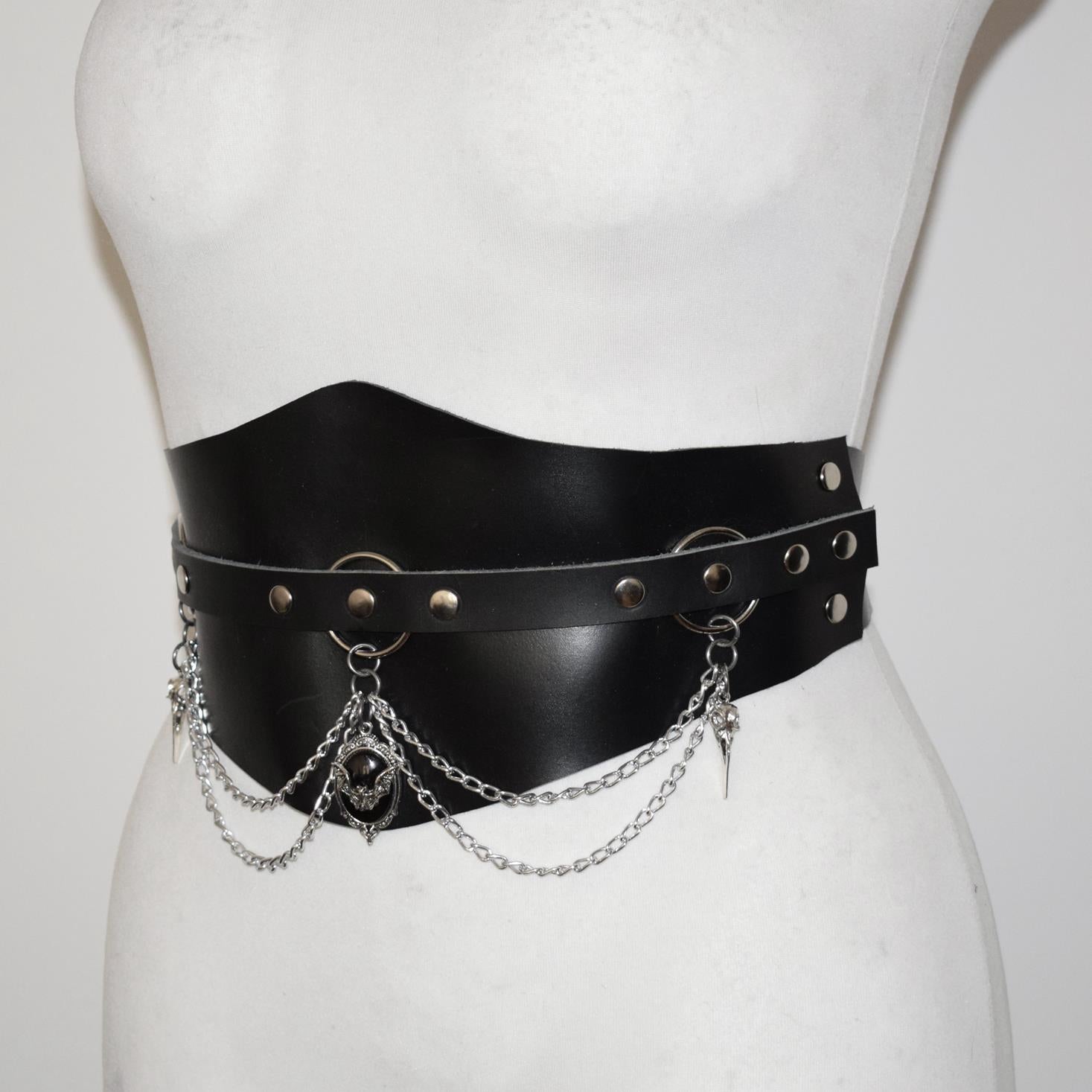 Black leather belt with chain details on a mannequin against a white background