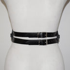 Black leather belt with silver buckles on a mannequin form against a white background