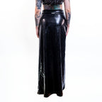 Black wet-look cut-out maxi skirt worn by a person on a white background
