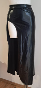 Black wet-look cut-out maxi skirt with cutout design on a mannequin against a plain background