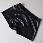 Black shiny pants on a light gray background