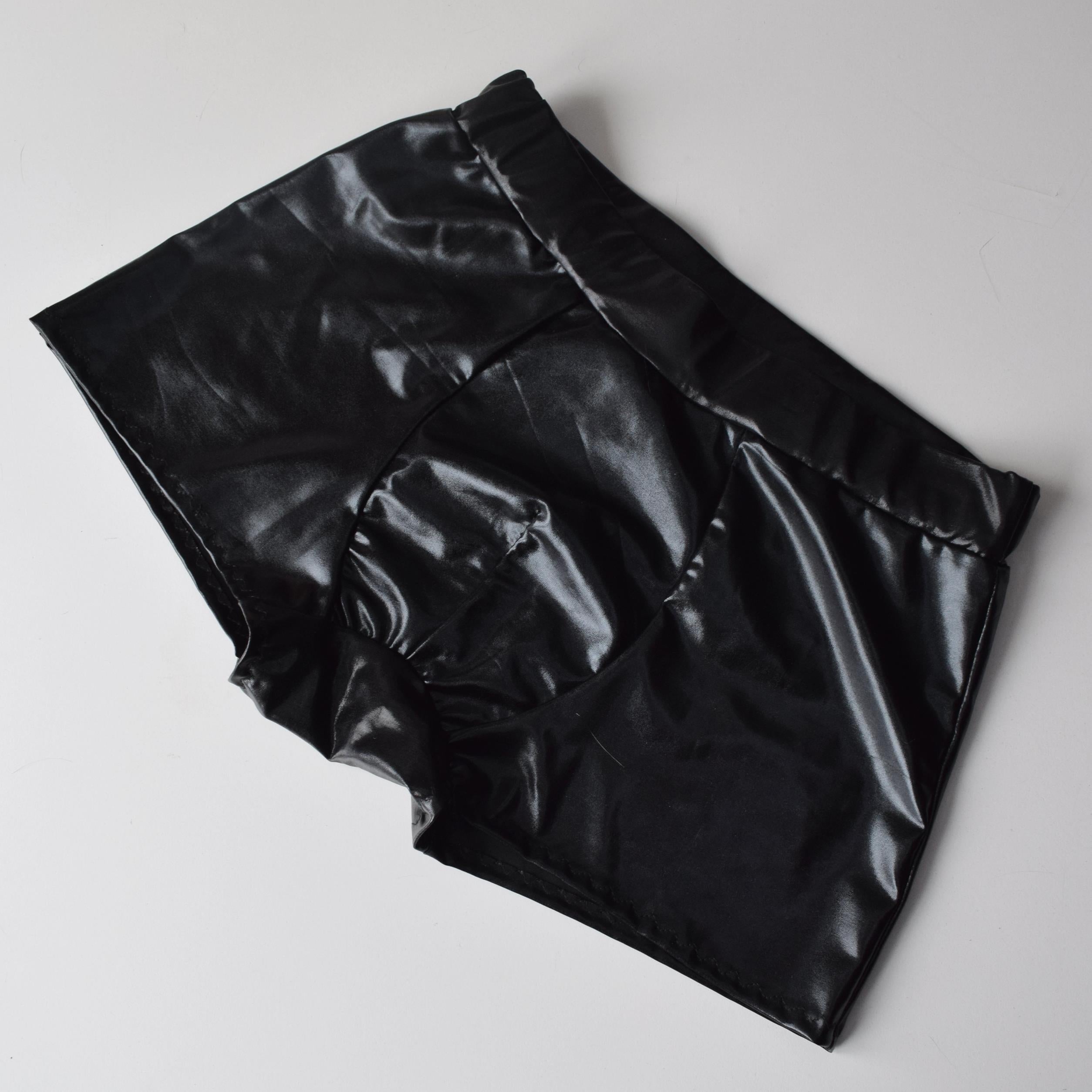 Black shiny pants on a light gray background