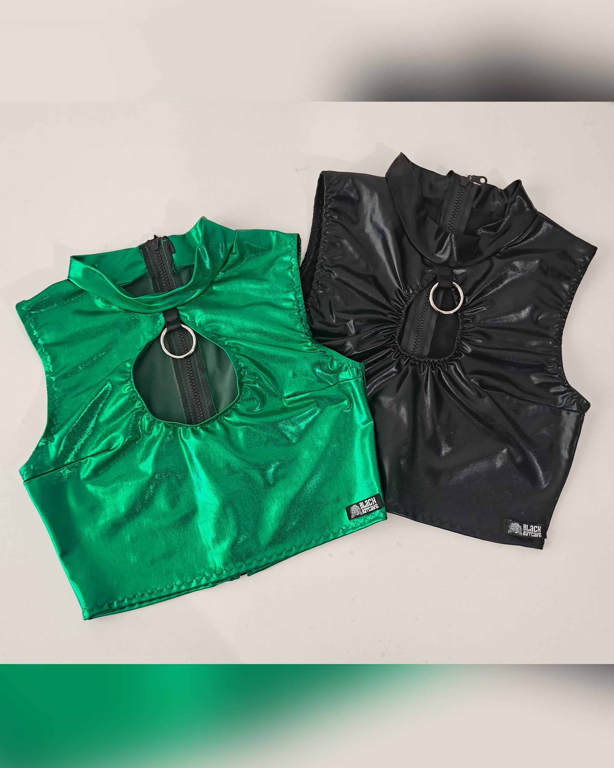 Green and black wet-look sleeveless crop top on a light gray background