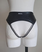 Black wet-look open crotch panties on a mannequin against a plain background