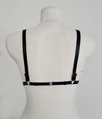 Black wet look triangle bra on a mannequin against a white background
