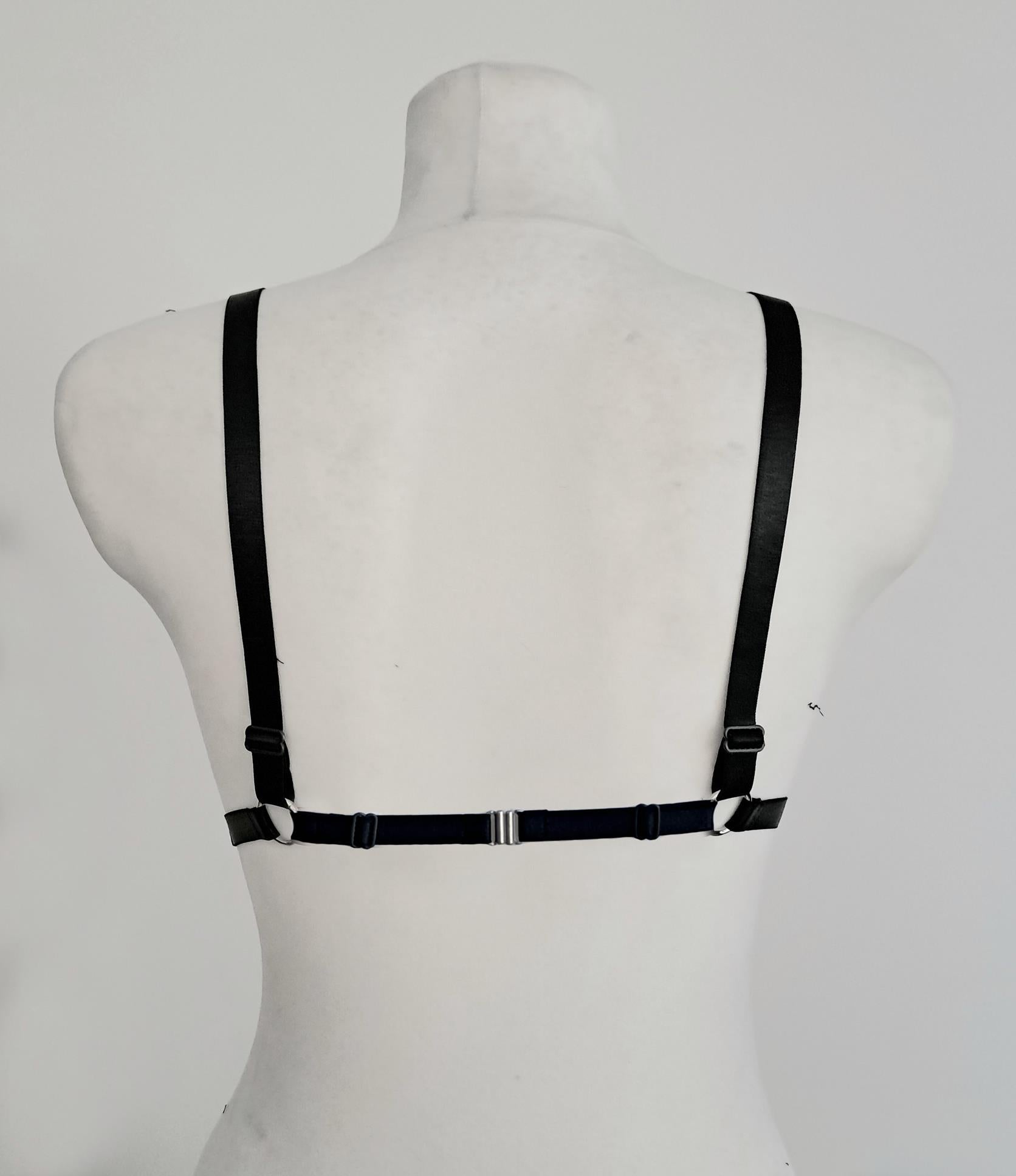 Black wet look triangle bra on a mannequin against a white background