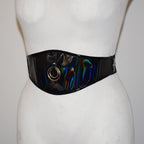 Mannequin wearing a wide, colorful belt with metallic accents on a plain background