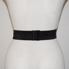 Black belt on a mannequin with a plain background
